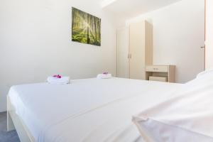 Postel nebo postele na pokoji v ubytování Apartments Latkovic
