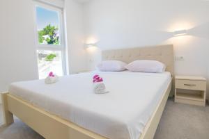 Postel nebo postele na pokoji v ubytování Apartments Latkovic
