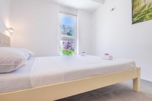 Postel nebo postele na pokoji v ubytování Apartments Latkovic
