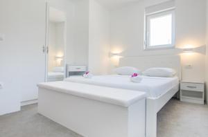 Postel nebo postele na pokoji v ubytování Apartments Latkovic