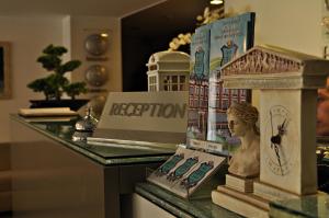 a display of books and a statue on a table at Hotel Edirne Palace in Edirne