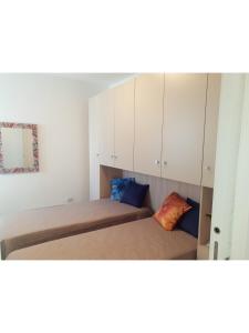 A bed or beds in a room at Island Apartment Porto Cesareo Még 31 kép