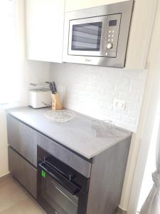 A kitchen or kitchenette at Island Apartment Porto Cesareo