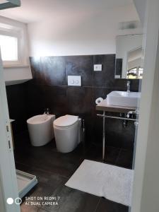 a bathroom with a toilet and a sink at B&B Residenza Leonardo in Falconara Marittima