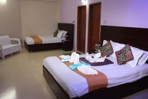 Ένα ή περισσότερα κρεβάτια σε δωμάτιο στο Royal Palm Hotel