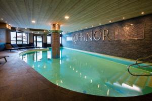 a large swimming pool in a hotel lobby at Résidence Koh-I Nor by Les Etincelles in Val Thorens