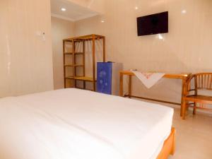 Guna Graha Kuta by Kamara tesisinde bir odada yatak veya yataklar