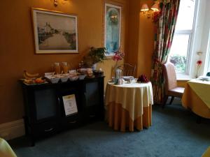 a room with a table with food on it at Bay Tree House Southport, United Kingdom in Southport