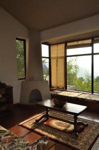 a living room with a table and a fireplace at Bhurban Valley Cottages 2 in Bhurban