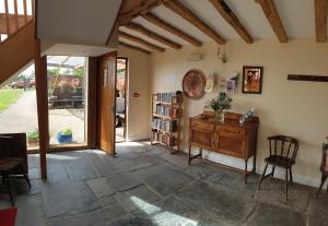 a room with a wooden desk and a book shelf at the old red lion in Bruton