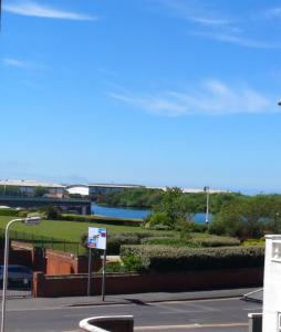a view of a river with a bridge in the background at Bay Tree House Southport, United Kingdom in Southport