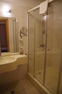 a bathroom with a shower and a sink at Mari Vila Hotel in Bucharest