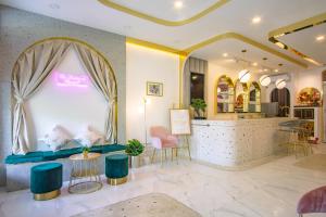 a salon with a blue couch and chairs and a counter at Isara Boutique Hotel and Cafe in Phuket