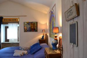 a bedroom with a bed with blue pillows on it at ValdericArte in Lamoli Di Borgo Pace