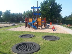 a playground in a park with two manholes in the grass at Apartamenty nad morzem & SPA BEST HOME 5 Mórz basen kryty in Sianozety