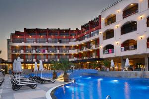 a hotel with a swimming pool in front of a building at Hotel Nobel Ultra All Inclusive - FREE Beach Access in Sunny Beach