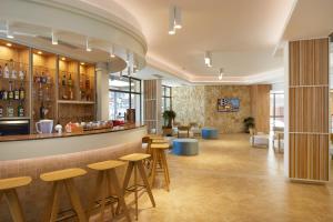eine Bar in einem Restaurant mit Hockern in der Unterkunft Hotel NOBEL Ultra All Inclusive - FREE Beach Access in Sonnenstrand