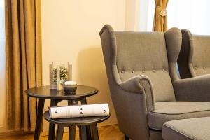 a living room with two chairs and a table at Sofia Place Hotel by HMG in Sofia