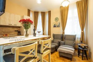 a kitchen with two chairs and a counter with a table at Sofia Place Hotel by HMG in Sofia