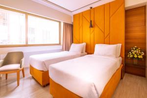 Postel nebo postele na pokoji v ubytování Hotel Metropole Inn