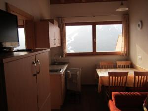 a small kitchen with a table and a window at Pircherhof in San Candido