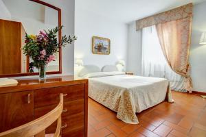 Postel nebo postele na pokoji v ubytování Hotel San Lino