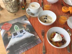 a table with two bowls of food and a magazine at Winterton in Lochgilphead +20 photos