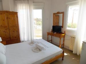 Postel nebo postele na pokoji v ubytování Hotel Sgouridis