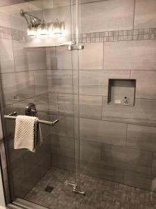 a bathroom with a shower with a glass door at Ocean View Hotel in Rocky Harbour