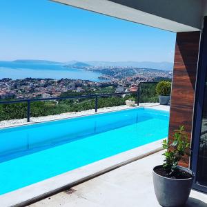 a swimming pool with a view of the water at Royal Villa 2 in Podstrana