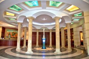 a lobby with columns and a vase in the middle at Hotel sv. Ludmila in Skalica