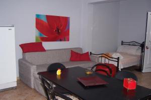 a living room with a couch and a table at Christina's House in Iraklitsa