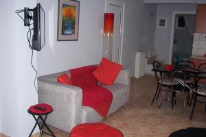 a living room with a gray couch with red pillows at Christina's House in Iraklitsa