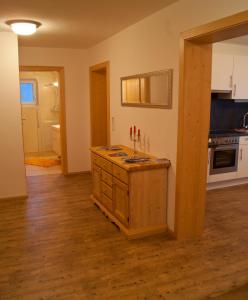 a kitchen with an island in the middle of a room at Apartment Sonnbichl in Schwendau