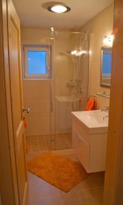 a bathroom with a shower and a sink and a tub at Apartment Sonnbichl in Schwendau