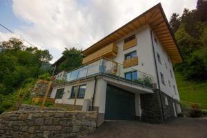 a large white house with a large garage at Apartment Sonnbichl in Schwendau