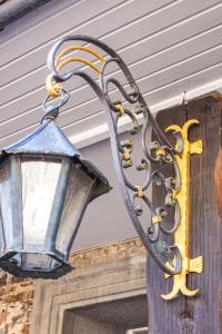 an outdoor light attached to a house with a cross at Landhaus Beth-Steuer in Valwig