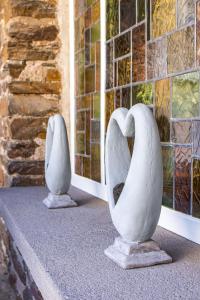 two white vases sitting on a ledge next to a window at Landhaus Beth-Steuer in Valwig