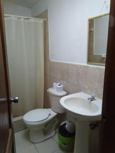 a bathroom with a toilet and a sink at My Best Stay Piedra del Mar in Puerto López +25 photos