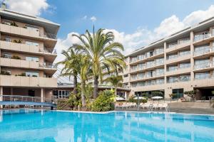 a large swimming pool in front of a hotel at AQUA Hotel Onabrava & Spa 4*Sup in Santa Susanna