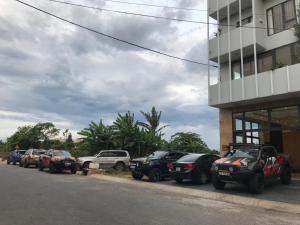 a row of cars parked next to a building at Windy Hotel Quang Binh in Dong Hoi