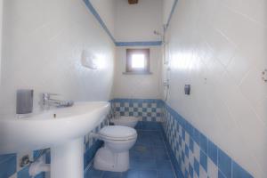 a blue and white bathroom with a toilet and sink at Venere Paolina - Goelba in Marciana