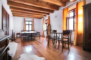 a living room with a dining room table and chairs at Royal Pension in Olomouc