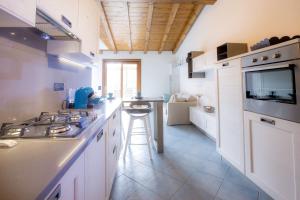 a kitchen with a stove and a counter top at Venere Paolina - Goelba in Marciana +7 photos