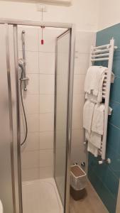 a shower with a glass door in a bathroom at Hotel Ristorante Il Gabbiano in Cecina