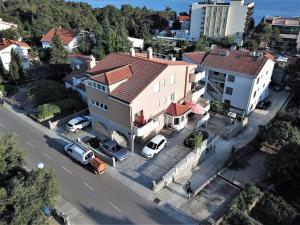an overhead view of a house with cars parked in a parking lot at Apartments VALL in Krk