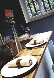 a wooden table with two glasses of wine on it at STUDIO VILLA NUI in Cuers