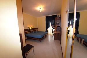 a living room with a blue bed and a table at Hotel Miramare in Porto Cesareo