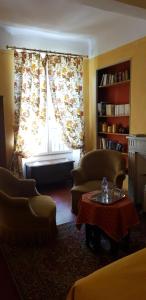 a living room with two chairs and a window at La Cordeline in Brignoles