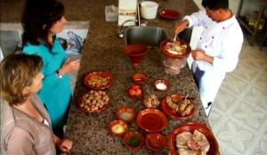 a group of people standing around a table with food at Dar Amalou in Imlil
